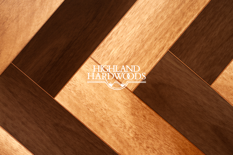 Hardwood floor with contrasting pattern of light and dark wood.