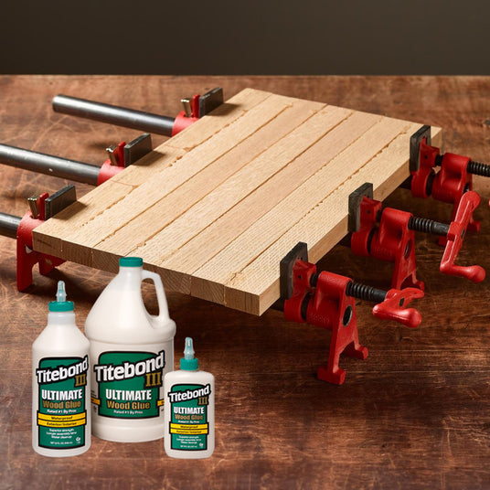 Pieces of wood being clamped together and joined using Titebond 3 Ultimate Wood Glue.